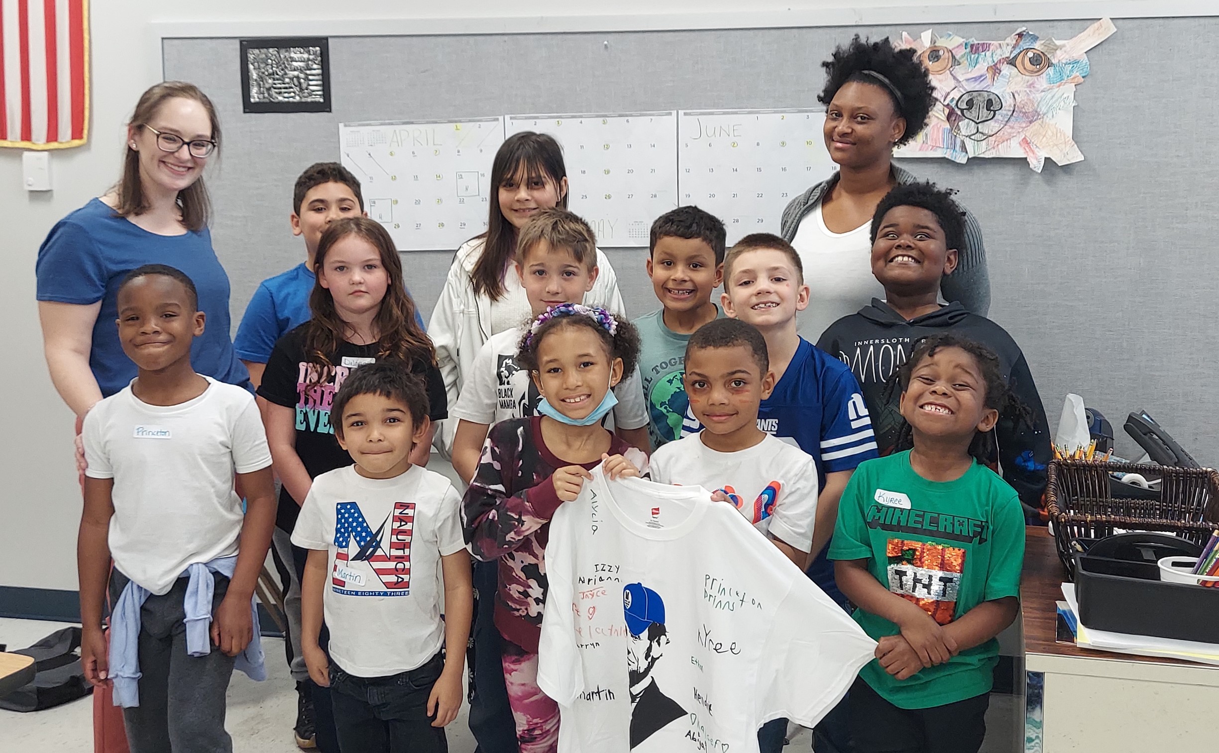 Students in the 21st Century Program at Wilcox Elementary holding up an LLCC T-shirt