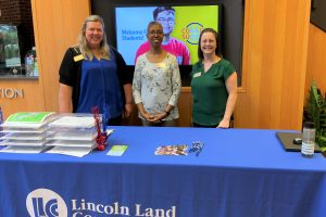 Shanda Byer, Leanne Roseberry and Leslie Johnson at the Welcome Week table in A. Lincoln Commons