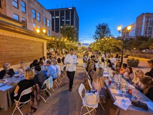 Event guests at tables along sidewalk in downtown Springfield