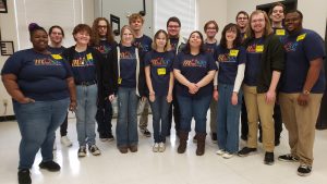 15 members of the LLCC Choir wearing their LLCC Music T-shirts.