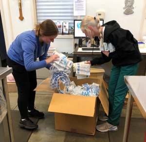 Two radiography students sorting through medical supplies