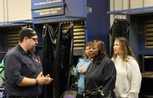 Sen. Hunter talking with faculty and students in welding lab