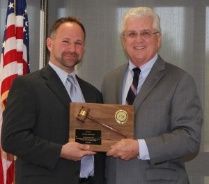 Outgoing LLCC Board Chair Justin Reichert is honored for his service by new Chair Craig Findley