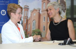 Charlotte Warren, Barbara Farley sign agreement