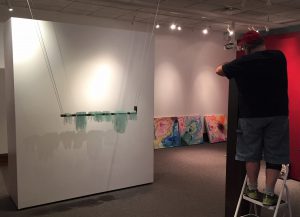 Bryon Hartley setting up artwork in museum