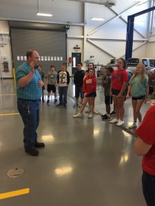 Brian Earley talking with students in the auto technology lab.