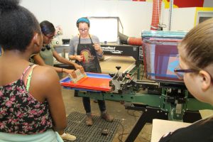 Leslie Stalter teaching screen printing to Career Launch teens