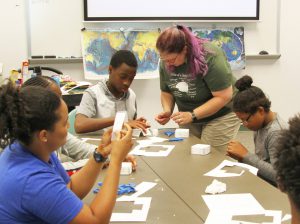 Samantha Reif working with Career Launch teens on paper models of faults