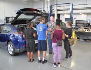Brian Earley showing Career Launch teens the automotive technology lab
