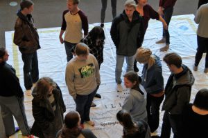 LLCC student GIS Day activity with giant floor map of Illinois