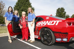 Evelyn Brandt Thomas with LLCC ag students in front of Brandt car