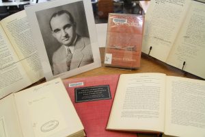 Photo of Dr. Benjamin P. Thomas and books from his collection