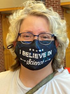 Samantha Reif wearing an "I believe in science" face mask