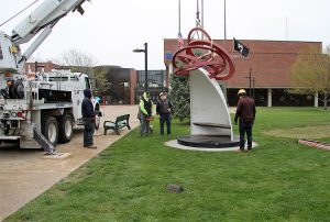 Moving the sculpture "Take Five" into position