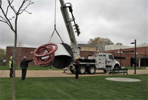 Moving the sculpture "Take Five" into position