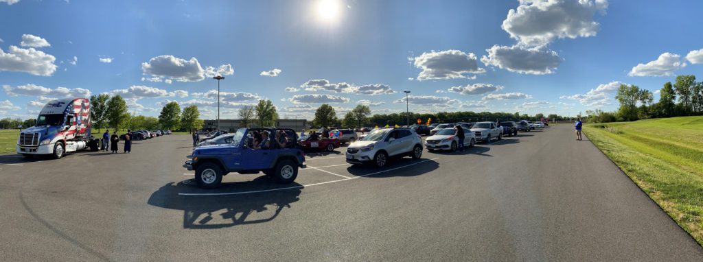 panoramic view of parade of vehicles lined up