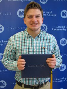 Kyle Cearlock holding Lincoln Land Community College diploma cover