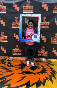 Lanphier student who will be attending LLCC holding frame