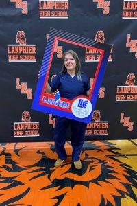Lanphier student who will be attending LLCC holding photo frame