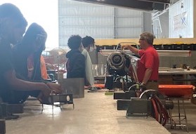 Students working in aviation hangar