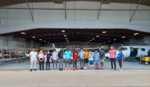 Boys & Girls Club youth with LLCC staff outside of aviation hangar