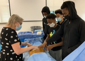 Dr. Cynthia Maskey in surgery bay with Career Launch teens