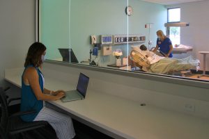 LLCC Nursing Instructor Bridgette Hudson observes nursing student Tracy Madonia as she practices skills in the labor/delivery lab of the new Nursing Education Center at LLCC. 