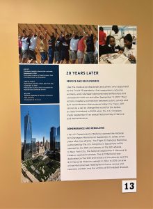 9/11 exhibit poster titled "20 Years Later" with subheadings of "Service and Selflessness" and "Remembrance and Rebuilding"