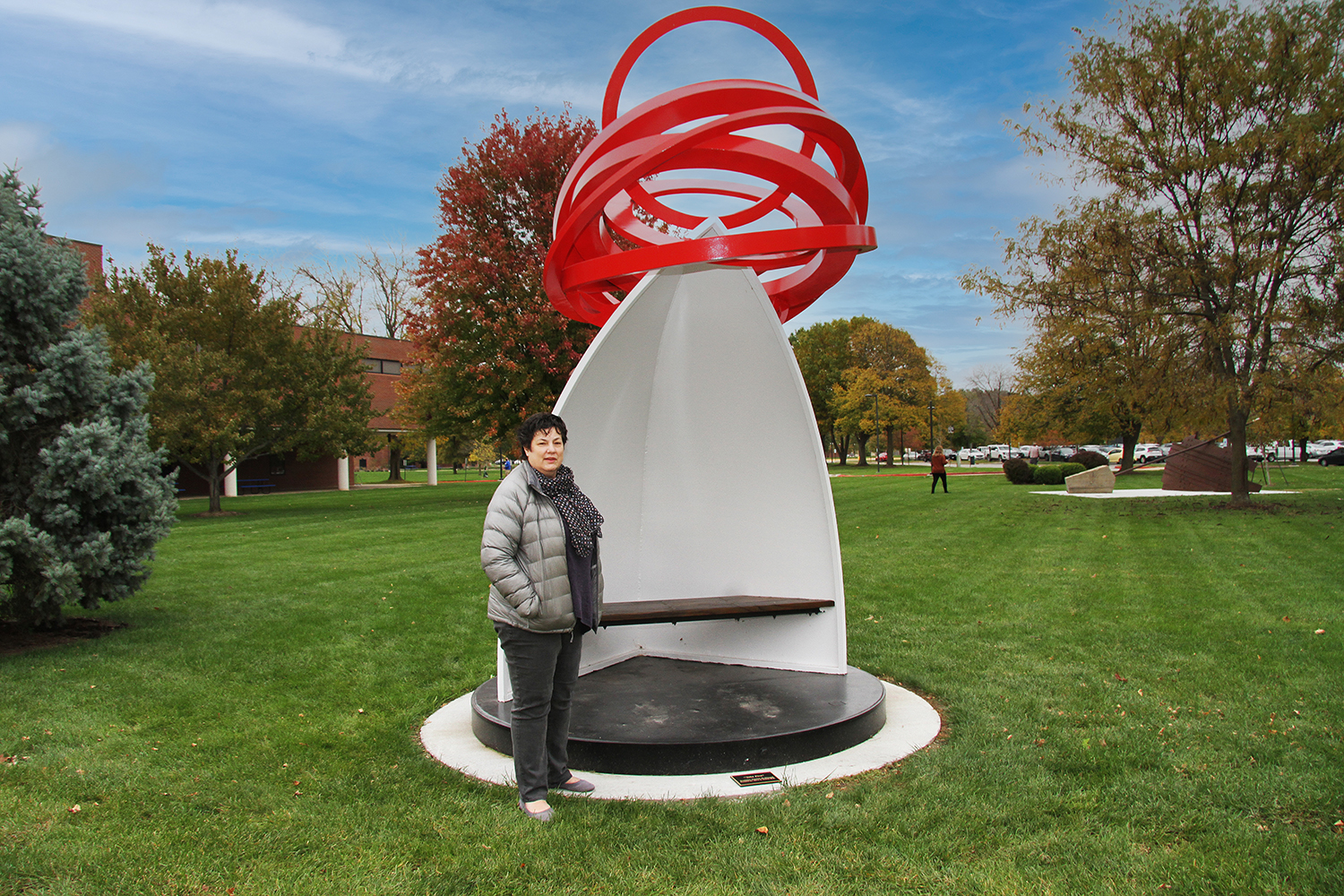Photo of Terri McKinzie with Take Five sculpture
