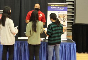 Patrick Moore talking to students at the High School Programs table