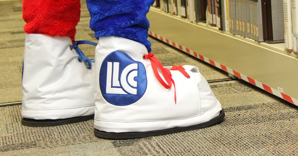 While sneaker with LLCC logo and red laces