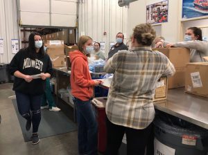 SRA club members pack boxes with medical supplies