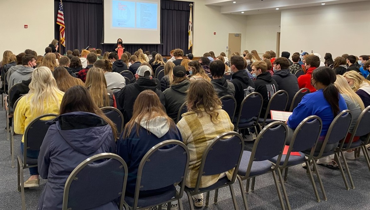 Students seated in auditorium listening to speaker