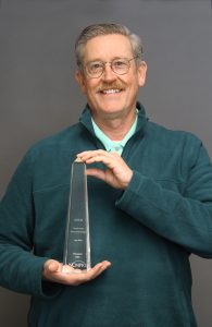 Greg Walbert holding Paragon award