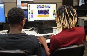 Two students working on Black Rocket gaming on a computer