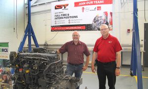 Jeff Gardner, director, LLCC diesel technologies program, and Chris Harrison, director of technical recruiting for CIT Trucks, with a donated MX-13 Paccar diesel engine to be used to train new diesel technicians. 