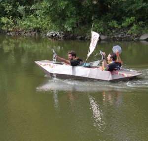 Chris and Chase from Enrollment Services paddling their boat