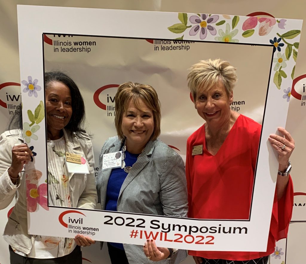 Michelle Pulce-Flynn, Karen Sanders and Brenda Elliott holding 2022 Symposium frame