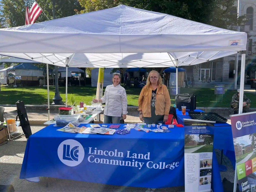 Jolene Lamb and Dee Krueger at LLCC table with info and swag