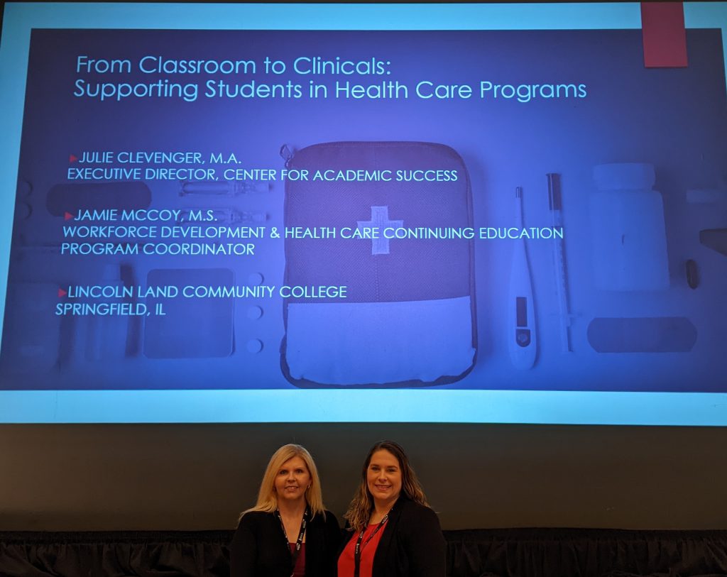 Jamie McCoy and Julie Clevenger stand in front of their presentation title screen “From Classroom to Clinicals: Supporting Students in Health Care Programs."
