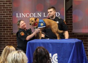 LLCC Police Officers Tammy Baehr and Scott McDermand with Pawfficer Ember at her swearing in ceremony
