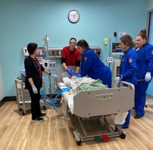 Nursing and respiratory care students resuscitating mannequin patient e