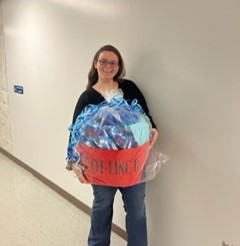 Courtney Todd holding prize basket with Linc blanket