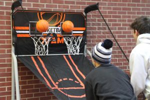 Two students participating in basketball challenge