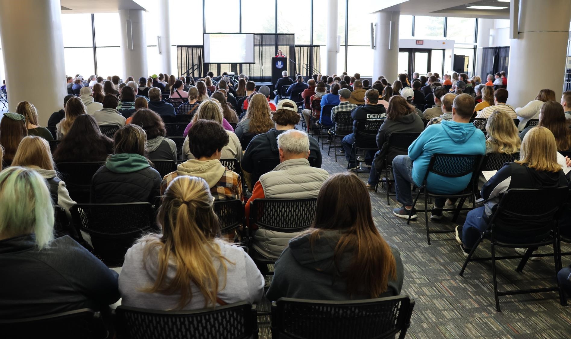 Mackenzie Bryant speaking to Campus Visit Day attendees seated in Student Union