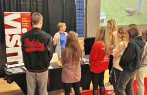 Gillian Bauer talking to students at the PTK exhibit