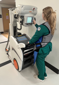 Radiography student using portable X-ray