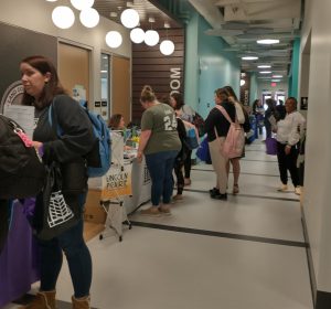 Students meeting with exhibitors in nursing hallway