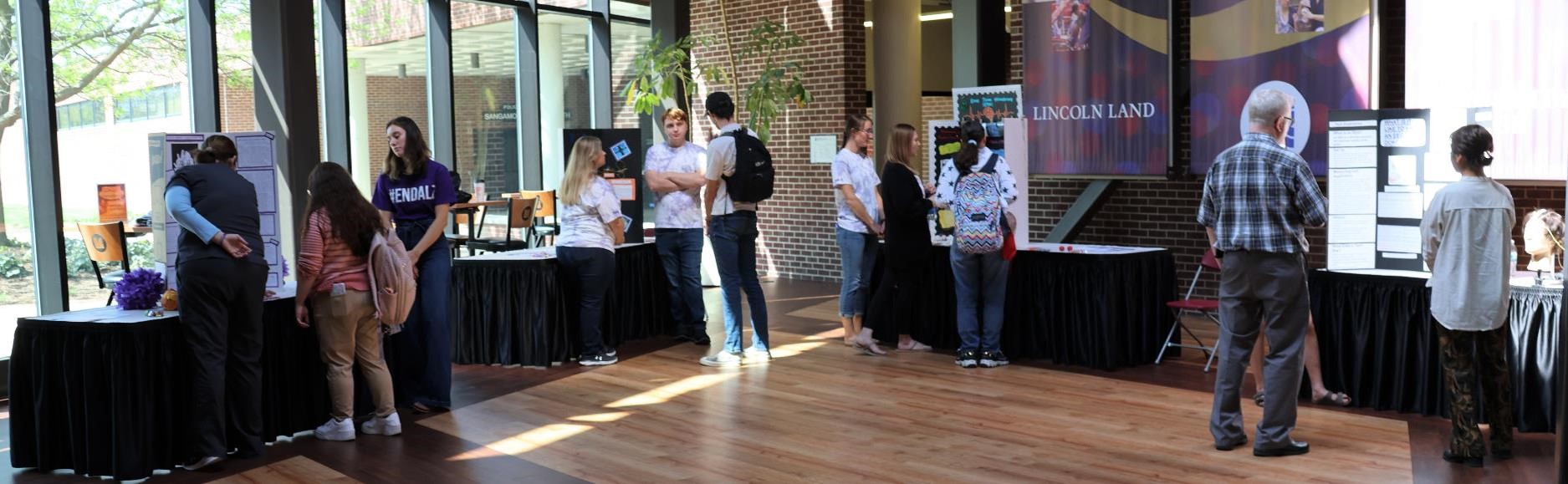 NDT students providing poster presentations at tables in A. Lincoln Commons