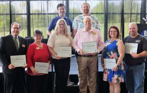 Eight members of 10-year service anniversary group